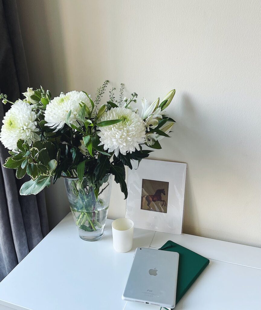 Home office desk with fresh flowers